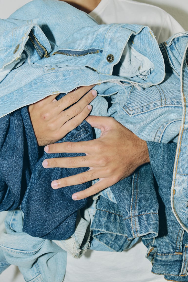 Man Holding Denim Clothes